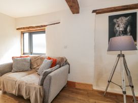 A living room with a sofa and lamp at The Bull Pen in Yeovil, Somerset