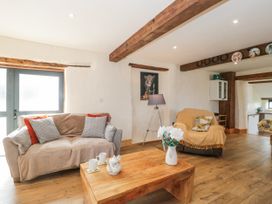 A living room with a sofa, armchair, and coffee table at The Bull Pen in Yeovil, Somerset