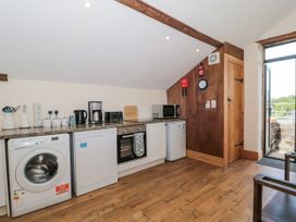 A kitchen with appliances and furniture at The Bull Pen Yeovil Somerset