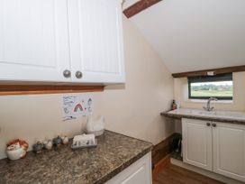 A kitchen with cabinets and a sink at The Bull Pen in Yeovil, Somerset