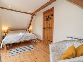 A bedroom with a bed and a sofa at The Bull Pen in Yeovil, Somerset