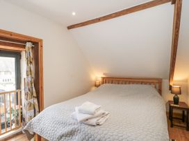 A bedroom with a bed and a window at The Bull Pen in Yeovil, Somerset