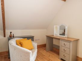 A bedroom with a chair, desk and mirror at The Bull Pen in Yeovil, Somerset