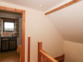 A landing with a staircase and a window at The Bull Pen in Yeovil, Somerset