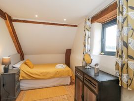 A bedroom with a bed and dresser at The Bull Pen in Yeovil, Somerset