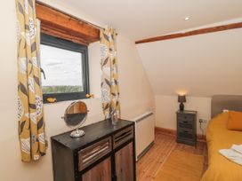 A bedroom with a dresser and window at The Bull Pen Yeovil, Somerset