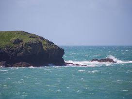 A coastal view with rocks and waves at Rowena in Mullion