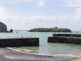 A view of an island and pier at Rowena in Mullion