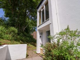 An exterior view of a white building entrance with plants and trees nearby at 37 Tamar in St Ann's Chapel near Callington