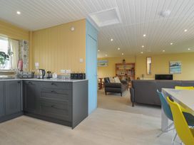 A kitchen and living area with furniture at 37 Tamar St Ann's Chapel near Callington