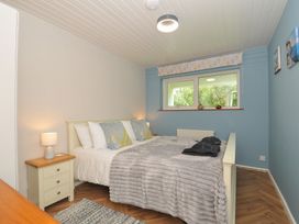 A bedroom with a bed and nightstand at 37 Tamar St Ann's Chapel near Callington
