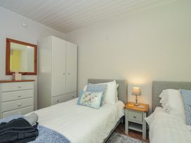 A bedroom with two beds and storage furniture at 37 Tamar in St Ann's Chapel near Callington