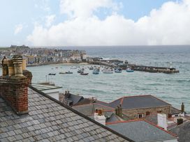 A harbor with boats and buildings at Harbour View in St Ives