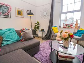 A living room with a sofa and a coffee table at Harbour View St Ives