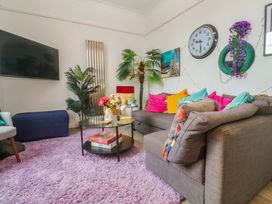 A living room with a sofa and television at Harbour View in St Ives