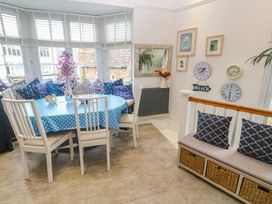 A dining room with a round table and chairs at Harbour View in St Ives