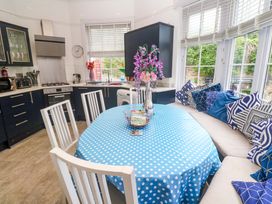 A kitchen with a round table and chairs at Harbour View in St Ives
