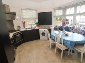 A kitchen with appliances and a dining area at Harbour View in St Ives