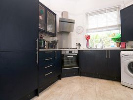 A kitchen with cabinets and appliances at Harbour View St Ives