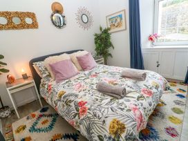 A bedroom with a bed and decorative elements at Harbour View in St Ives