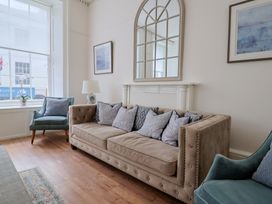 A living room with a sofa and armchairs at FLAT 1 53a Broad Street (1 Bedroom Sleeping 2) Lyme Regis
