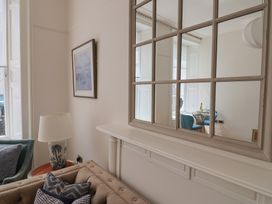 A living room with a couch and lamp at FLAT 1 53a Broad Street (1 Bedroom Sleeping 2) Lyme Regis