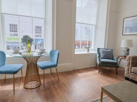 A dining area with table and chairs at FLAT 1 53a Broad Street (1 Bedroom Sleeping 2) in Lyme Regis
