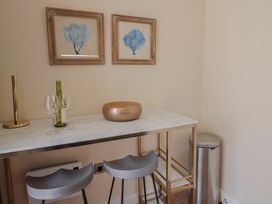 A dining room with a bar table and stools at FLAT 1 53a Broad Street (1 Bedroom Sleeping 2) Lyme Regis