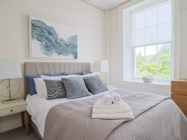 A bedroom with a bed and window at FLAT 1 53a Broad Street (1 Bedroom Sleeping 2) Lyme Regis