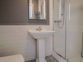 A bathroom with a sink and shower at FLAT 1 53a Broad Street (1 Bedroom Sleeping 2) Lyme Regis