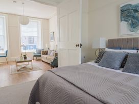 A bedroom with a bed and a seating area at FLAT 1 53a Broad Street (1 Bedroom Sleeping 2) Lyme Regis