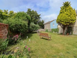 A garden with a bench and flowers at FLAT 1 53a Broad Street (1 Bedroom Sleeping 2) Lyme Regis