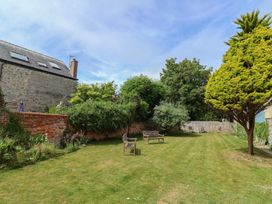A garden with benches and trees at FLAT 1 53a Broad Street (1 Bedroom Sleeping 2) Lyme Regis