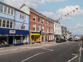A street with shops and cars at FLAT 1 53a Broad Street (1 Bedroom Sleeping 2) Lyme Regis