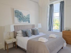 A bedroom with a bed and bedside tables at The Tides in Lyme Regis