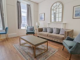 A living room with a sofa and coffee table at The Tides in Lyme Regis