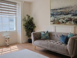 A living room with a couch and artwork at FLAT 2 53a Broad Street (1 Bedroom Sleeping2) Lyme Regis