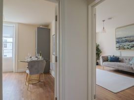 A dining area and living room with a dining table and sofa at FLAT 2 53a Broad Street (1 Bedroom Sleeping2) Lyme Regis