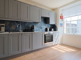 A kitchen with cabinets and appliances at FLAT 2 53a Broad Street (1 Bedroom Sleeping2) Lyme Regis