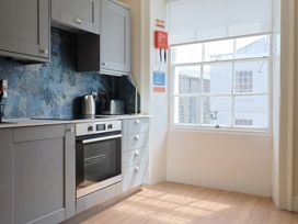 A kitchen with an oven and kettle at FLAT 2 53a Broad Street (1 Bedroom Sleeping2) Lyme Regis