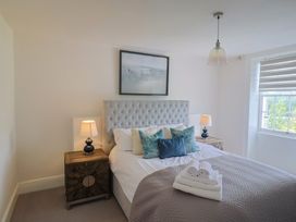 A bedroom with a bed and nightstands at FLAT 2 53a Broad Street (1 Bedroom Sleeping2) Lyme Regis