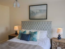 A bedroom with a bed and nightstands at FLAT 2 53a Broad Street (1 Bedroom Sleeping2) Lyme Regis