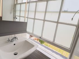 A bathroom with a sink and window at FLAT 2 53a Broad Street (1 Bedroom Sleeping2) Lyme Regis