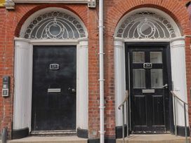Two black doors with numbers 53A and 54A at Saltwind Lyme Regis