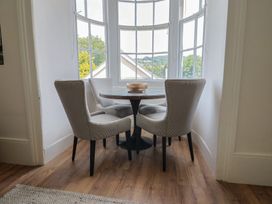 A dining area with a table and chairs at Saltwind in Lyme Regis