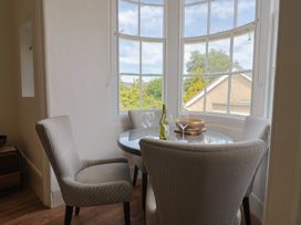 A dining room with a table and chairs at Saltwind in Lyme Regis