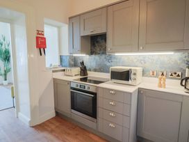 A kitchen with cabinets and appliances at Saltwind in Lyme Regis