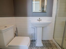 A bathroom with a toilet, sink, and shower at Saltwind in Lyme Regis