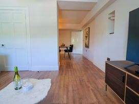 A living room with a table and chairs at Pebble Cove Lyme Regis