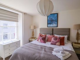 A bedroom with a bed and furniture at Pebble Cove in Lyme Regis